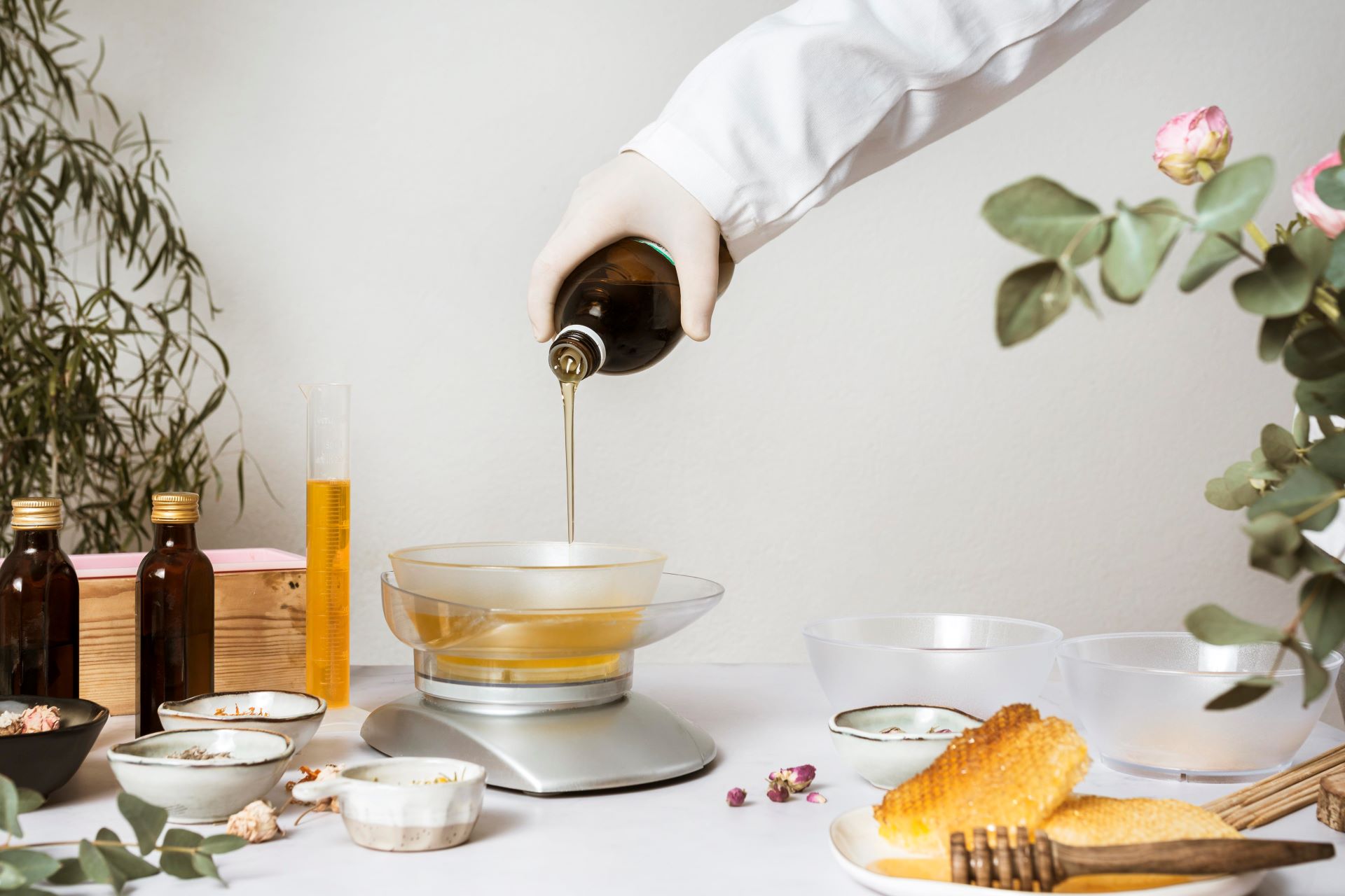 chemist pouring chemical into batch of soap