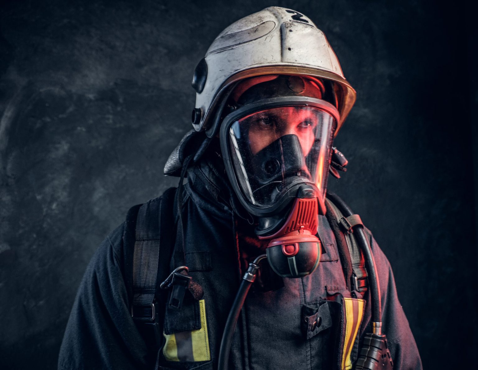 firefighter wearing a full face gas mask