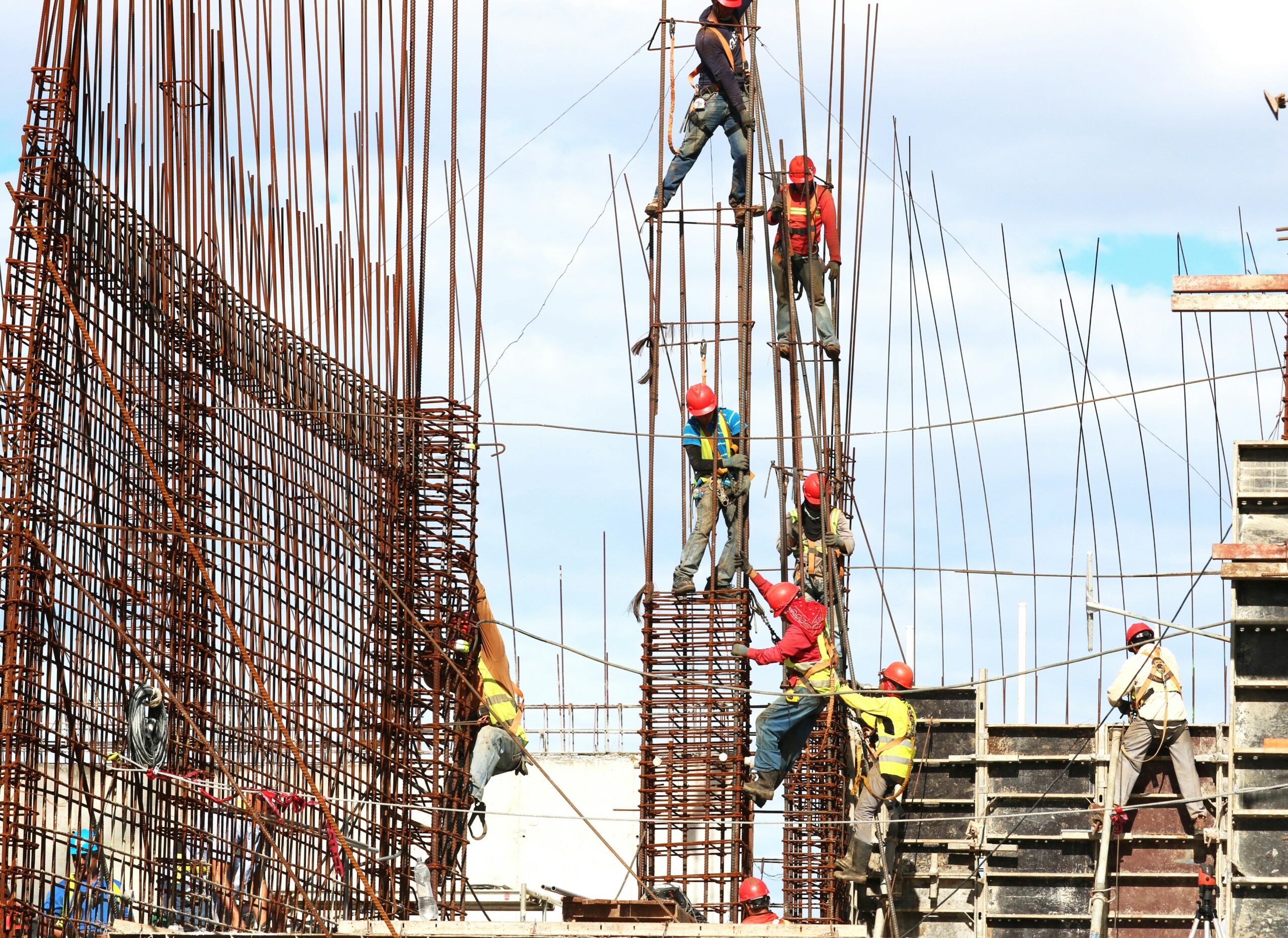 Construction workers using dextrose-enhanced drywall, showcasing its role in improving the strength and efficiency of modern building structures.