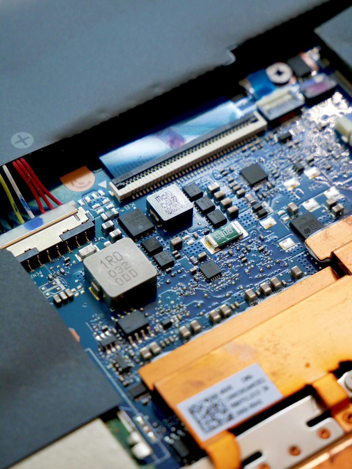 A close-up view of a computer circuit board, showcasing various electronic components and connections, highlighting advances in material science.