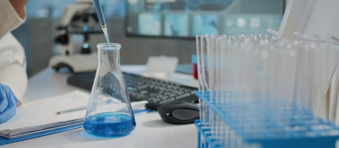 Chemical engineer putting chemical solution in a beaker