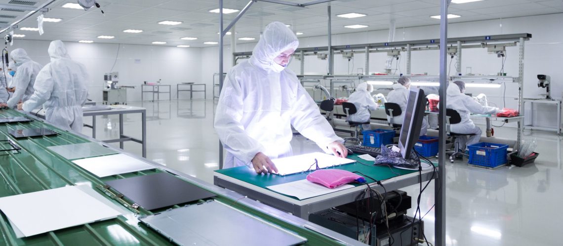 factory worker working with high purity chemicals to build television