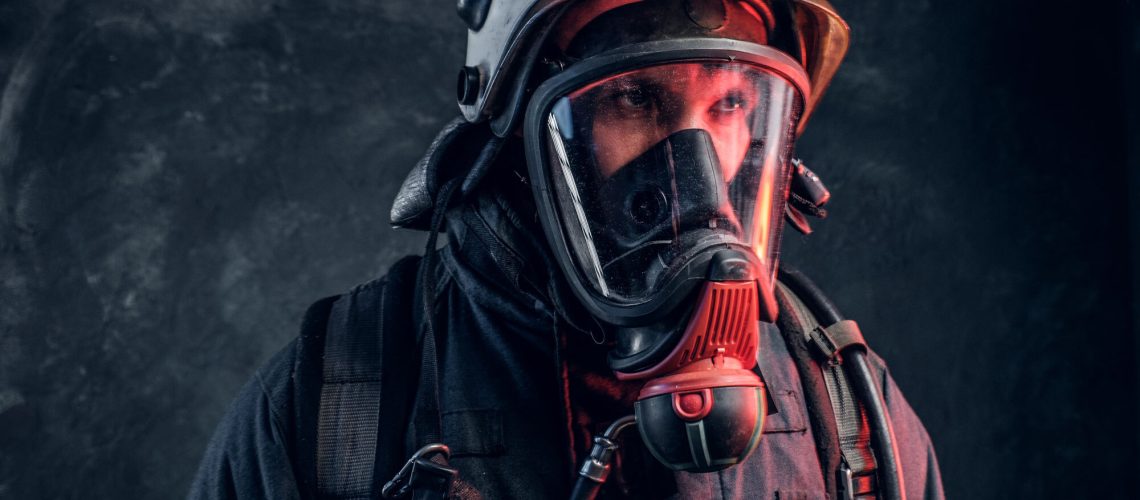 firefighter wearing a full face gas mask