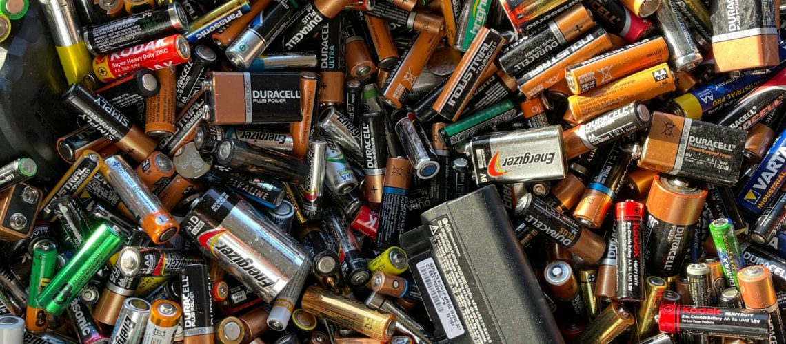 A collection of various used batteries, including alkaline, lithium-ion, and rechargeable types, highlighting the role of cobalt compounds in energy storage.