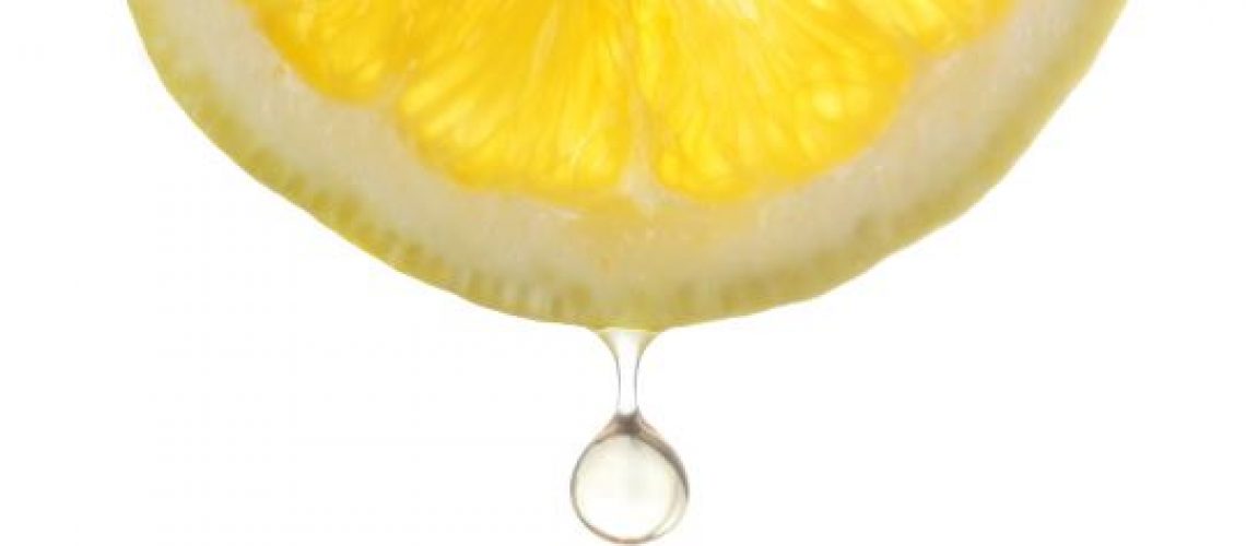 citric acid dripping off of a lemon slice
