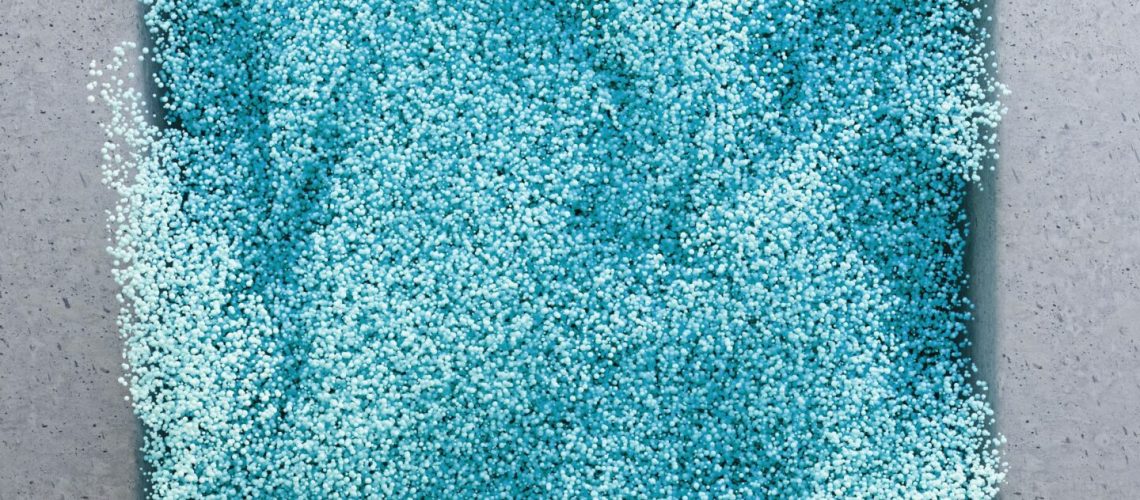 A close-up view of fine blue particles, inspired by the appearance of lanthanum compounds, arranged on a flat surface.