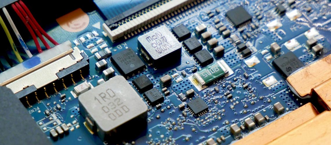 A close-up view of a computer circuit board, showcasing various electronic components and connections, highlighting advances in material science.